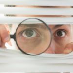 spying-through-window-with-magnifying-glass